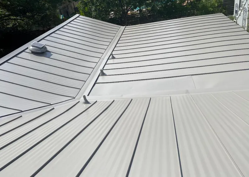 Solar attic fan installed on a metal roof for Roof Ventilation in Gas City